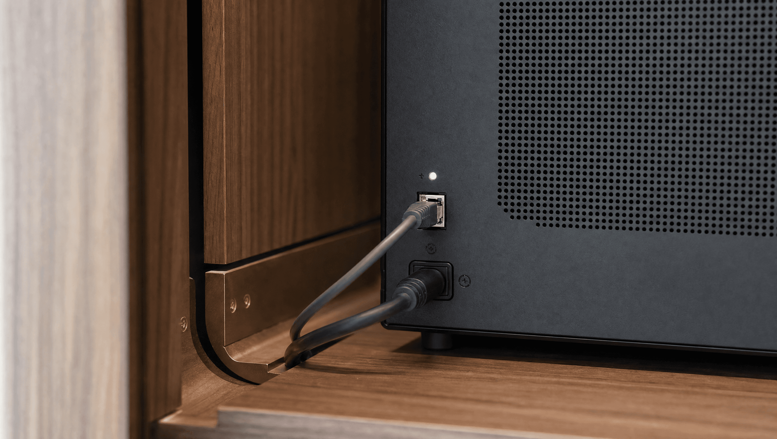 A freshly connected network cable on the rear panel of the Enclos appliance