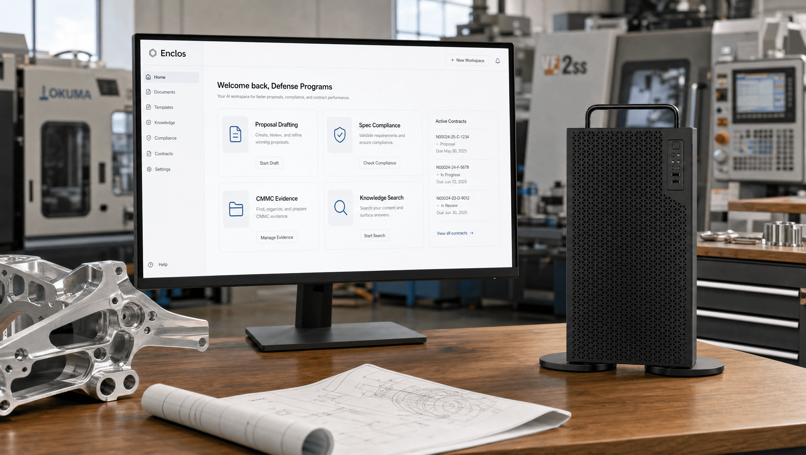 The Enclos system in a defense manufacturing facility: a desktop monitor running the private workspace beside the Enclos appliance